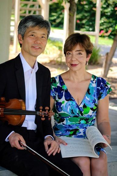 Musicians holding violin and musical book